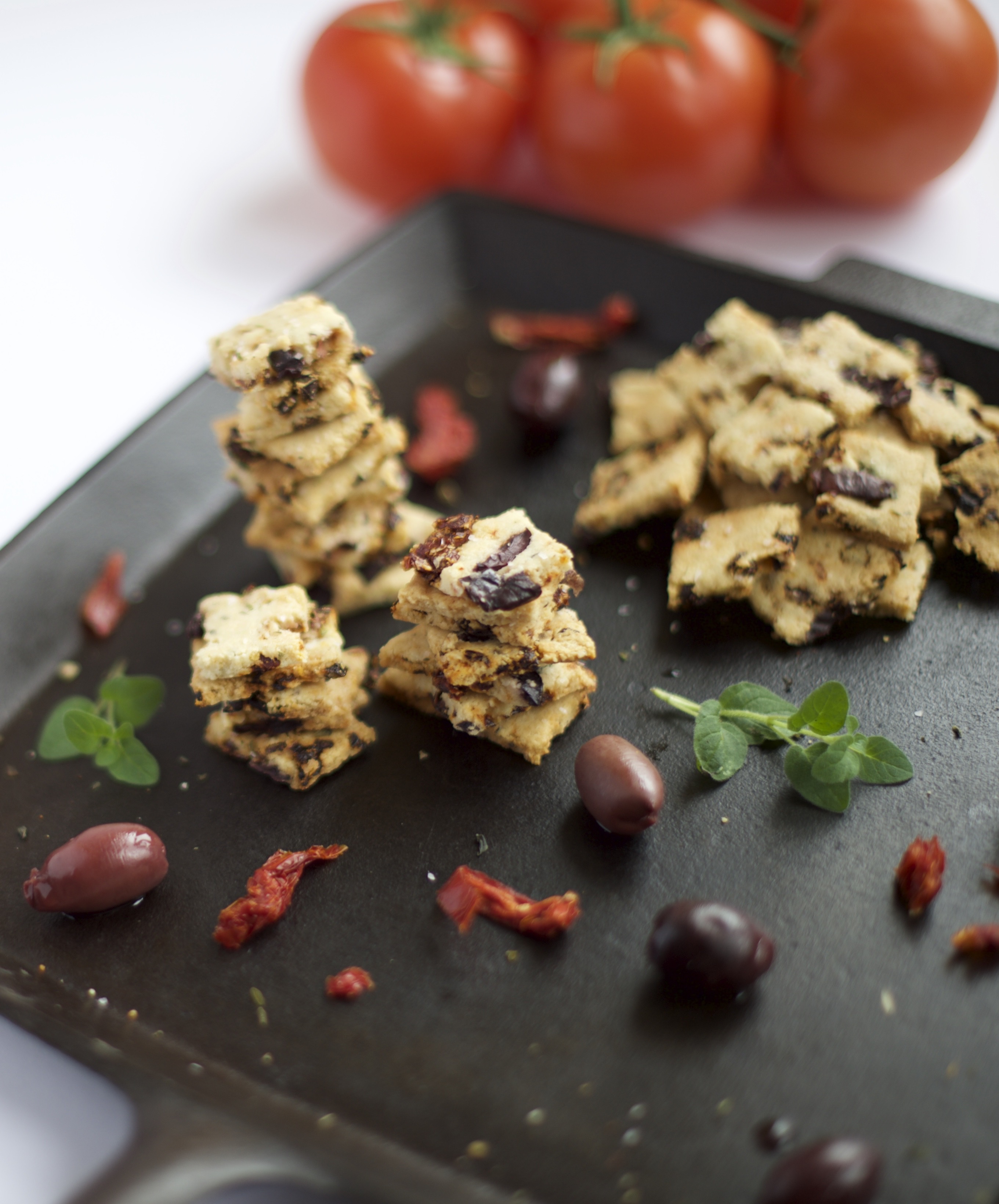 Photo of Grain Free Sun-Dried Tomato and Olive Crackers on a plate.