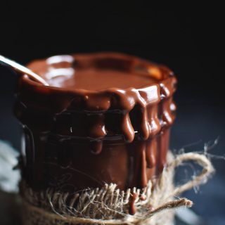 Low-Carb Chocolate Hot Fudge in a glass jar with burlap ribbon.