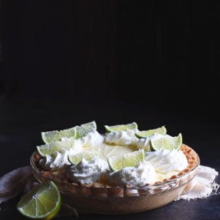 Photo of whole low-carb key lime pie with dark background.
