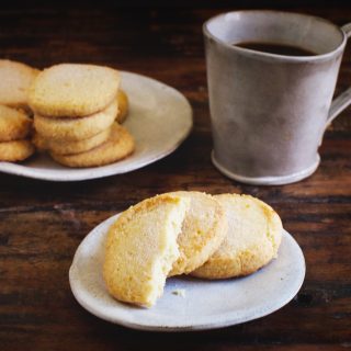 Low-Carb Sugar Cookies on a plate. One has bite taken out.