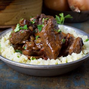 Low-Carb Beef Bourguignon Stew served over riced cauliflower.