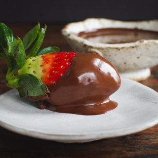 Sugar Free Chocolate Covered Strawberries-one dipped and on serving plate. Also shows chocolate ganache.