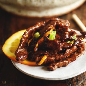Orange Beef - Low-Carb Chinese Food Recipe on a plate with orange slice garnish.