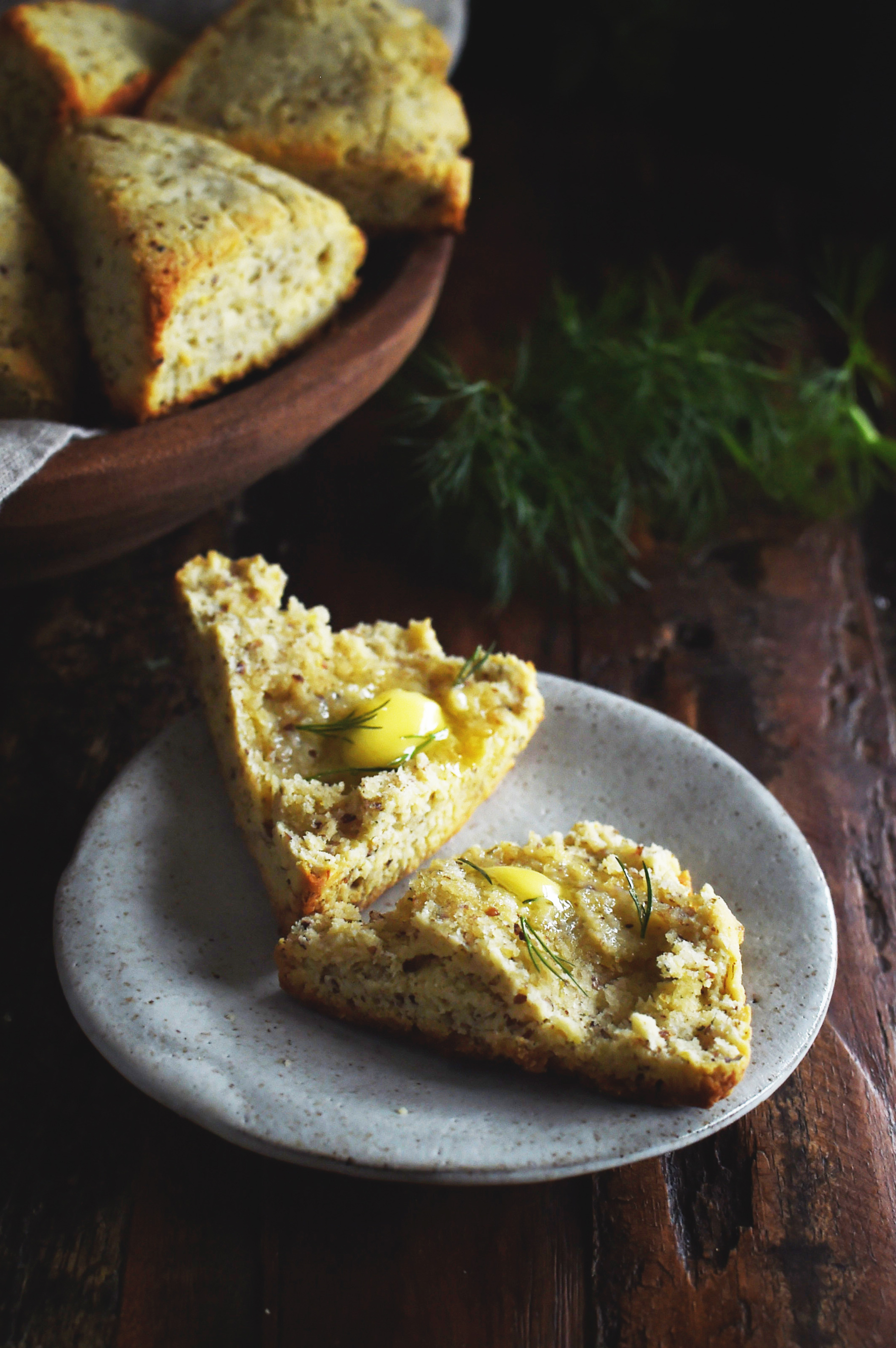 Low-Carb Onion Dill Savory Scones -split with butter spread on each piece.