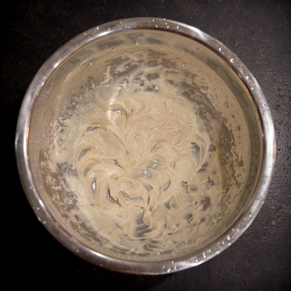 Process photo of sweetener and cream blended together to glaze-like consistency.