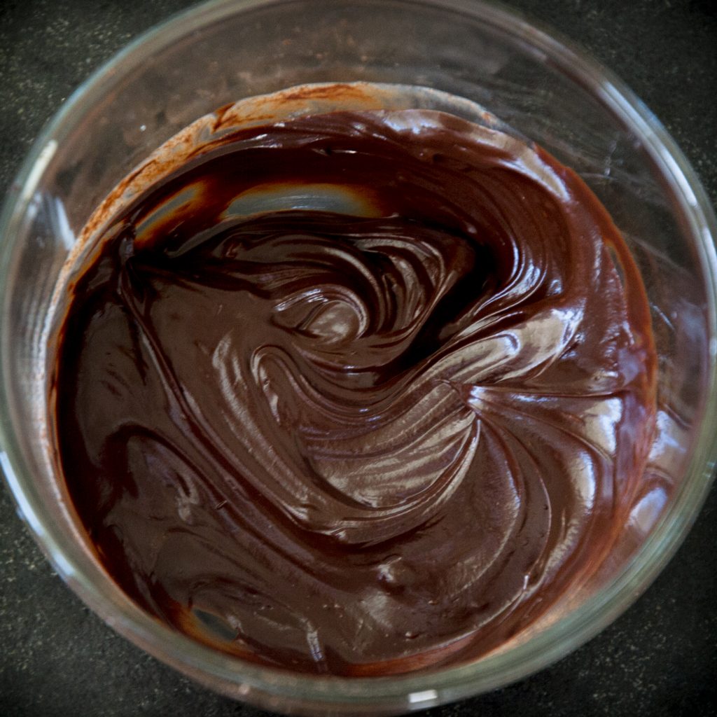 Process photo of completed ganache in a glass bowl.