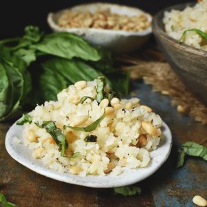 Cauliflower Rice Pilaf Recipe-Served on a plate with nuts and basil