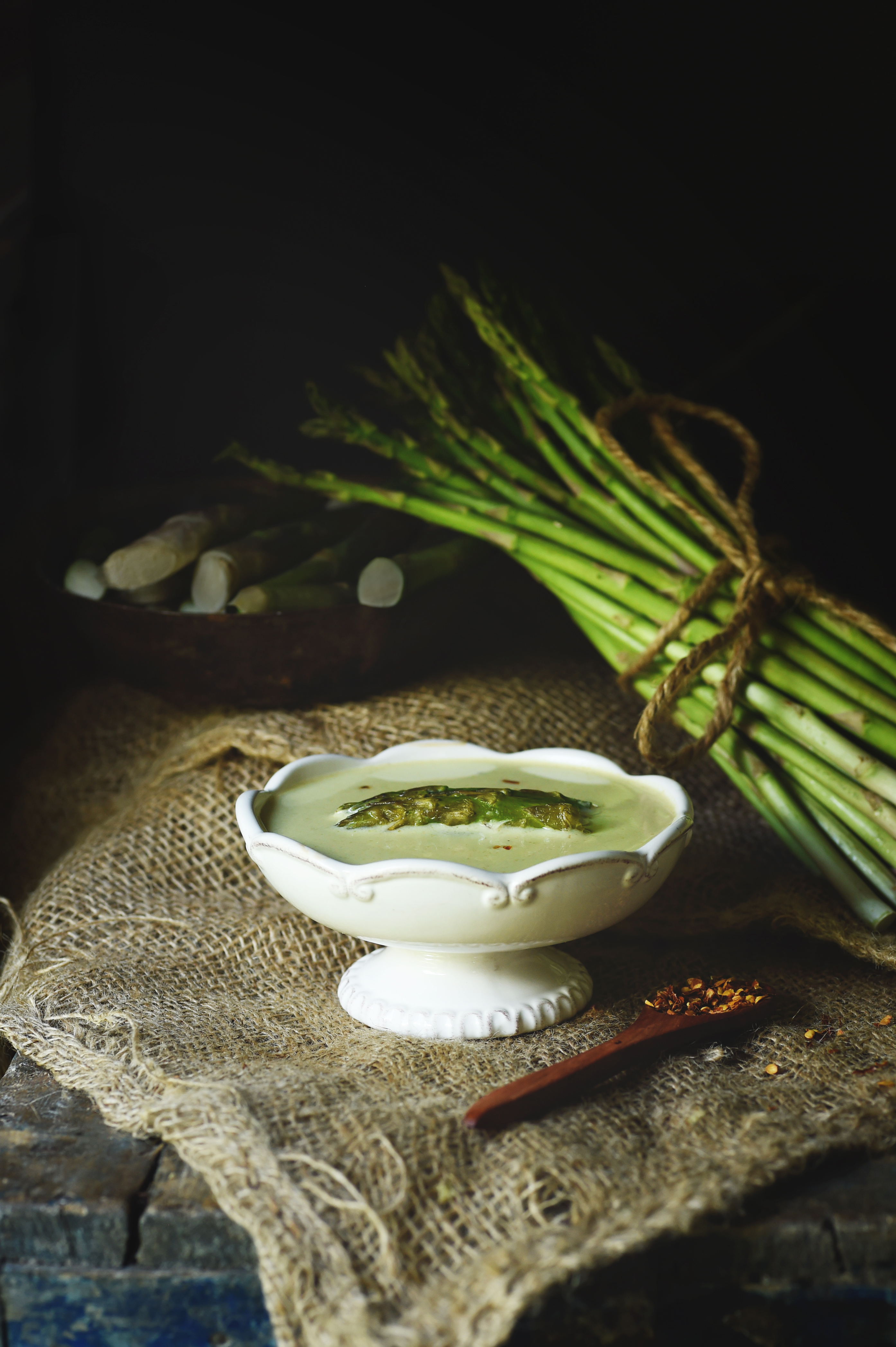 Low-Carb Cream of Roasted Asparagus Soup recipe -served in a footed bowl.