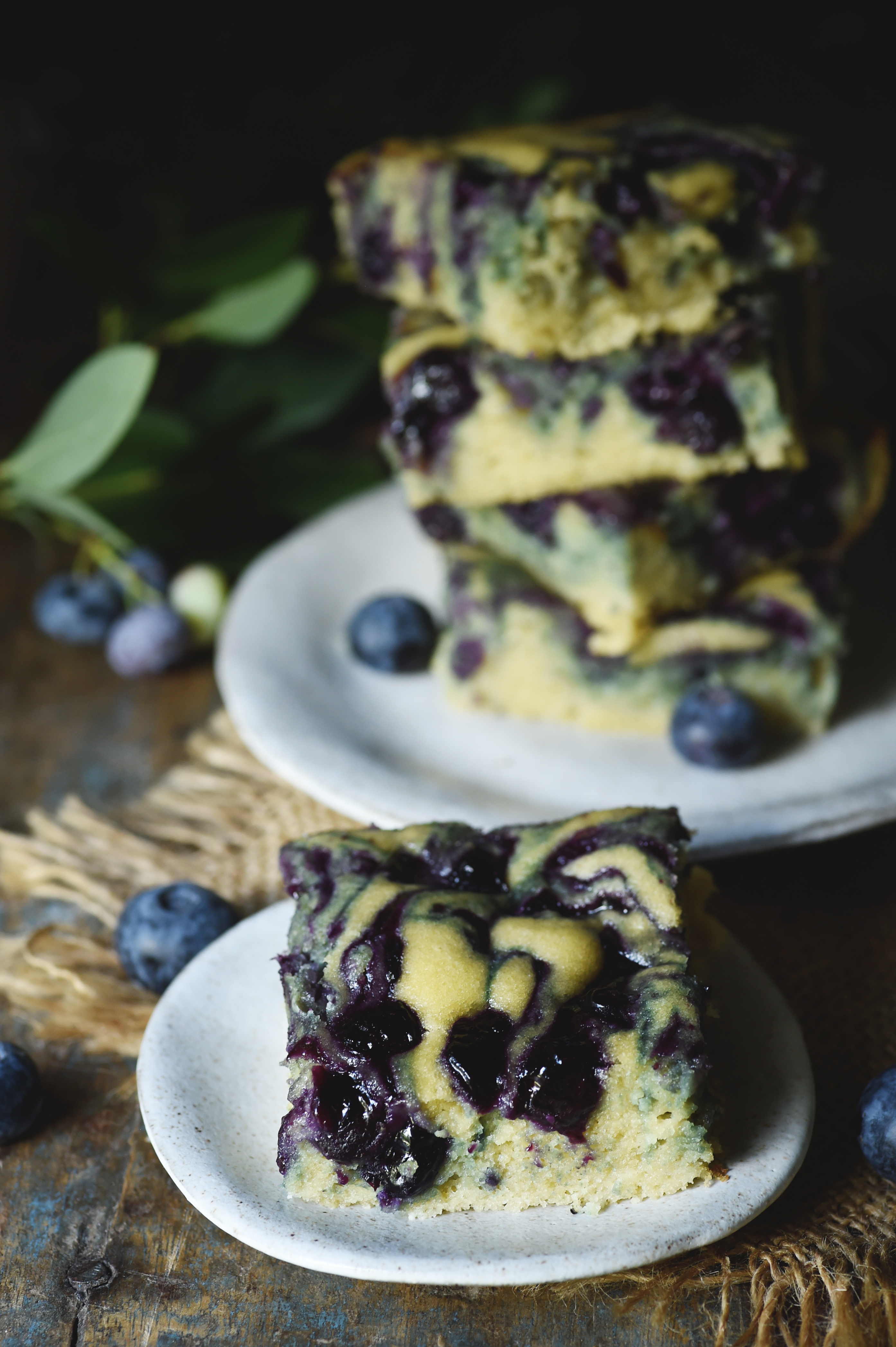 Low-Carb Blueberry Almond Flour Coffee Cake-one on a dessert plate with the stack behind. 