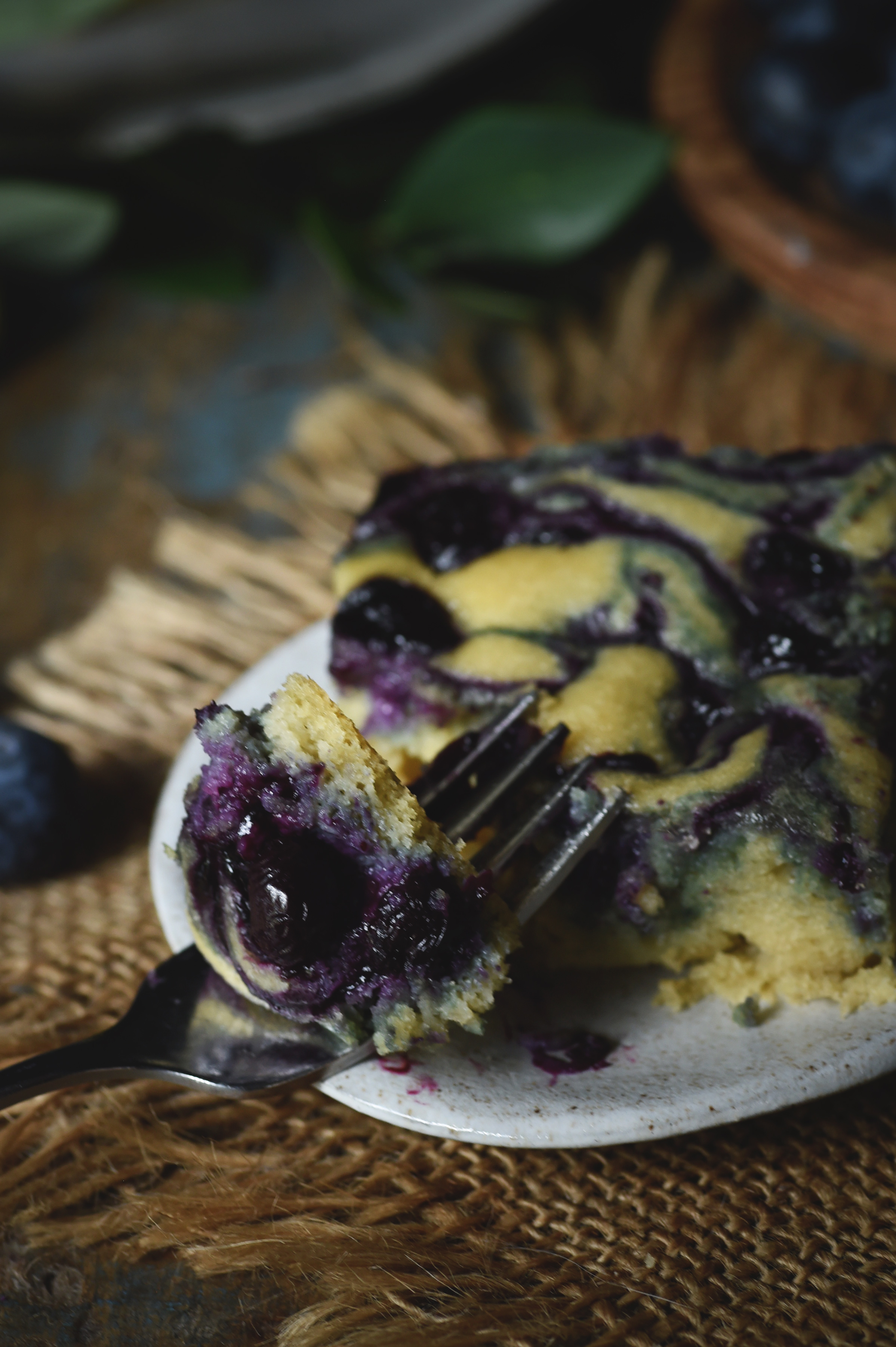 Low-Carb Blueberry Almond Flour Coffee Cake-a bite on a fork resting on plate.