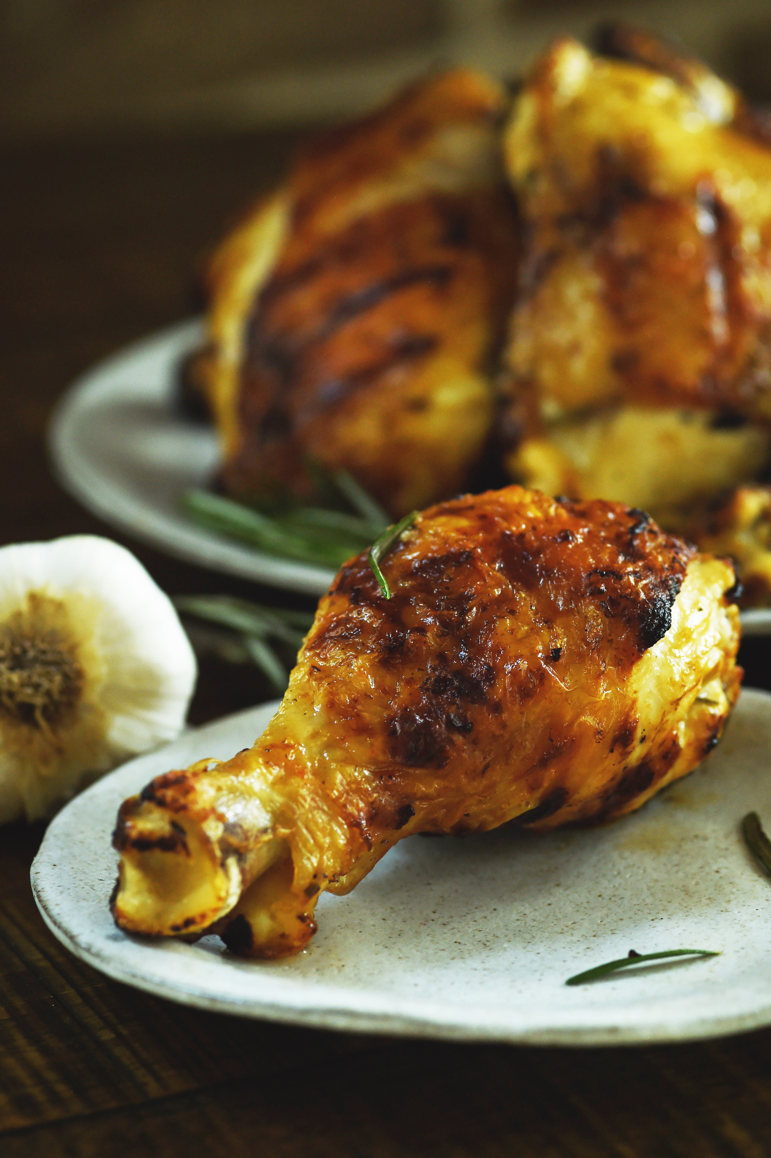 Grilled Rosemary Lemon Chicken -drumstick on a plate ready for eating.
