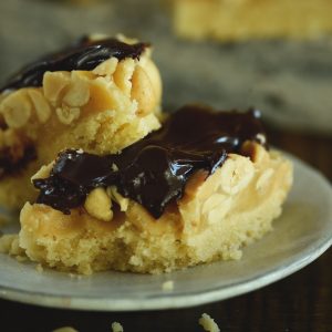 The Best Homemade Low-Carb Snickers Bars-Square photo on serving plate.