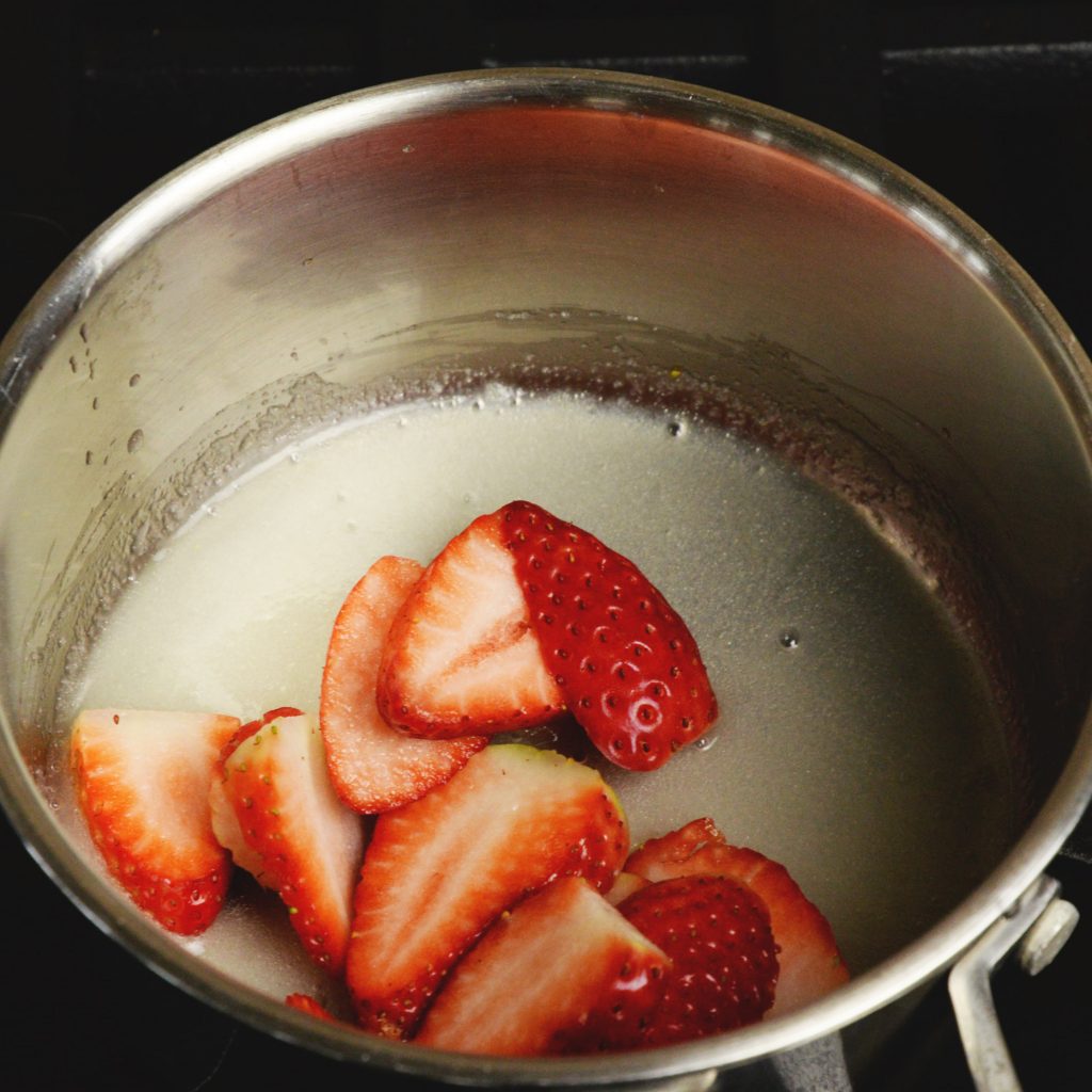 Low-Carb Strawberry Cheesecake Chia Pudding-adding the strawberries to the syrup.