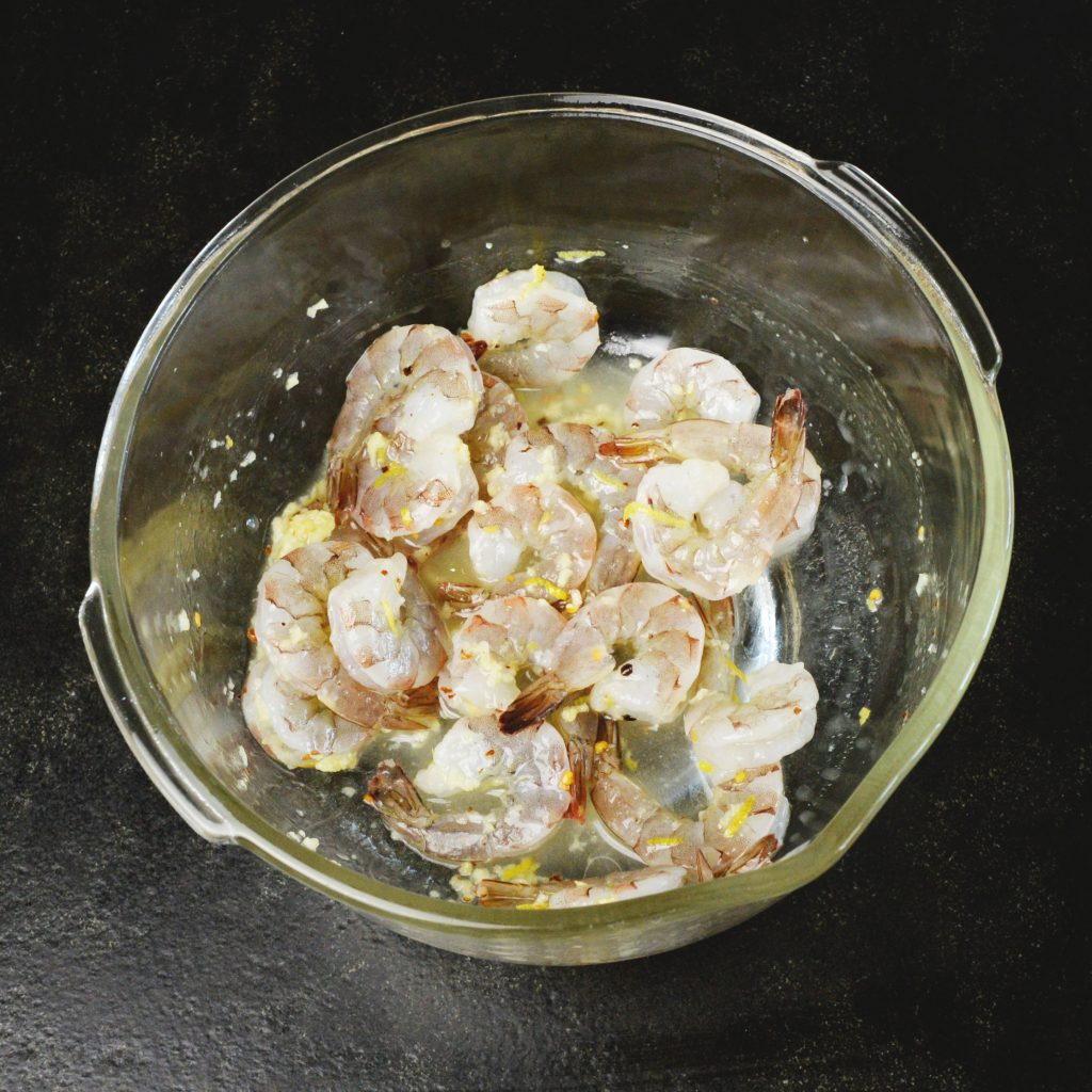 Lemon Garlic Shrimp Sheet Pan Dinner -Coating the shrimp.