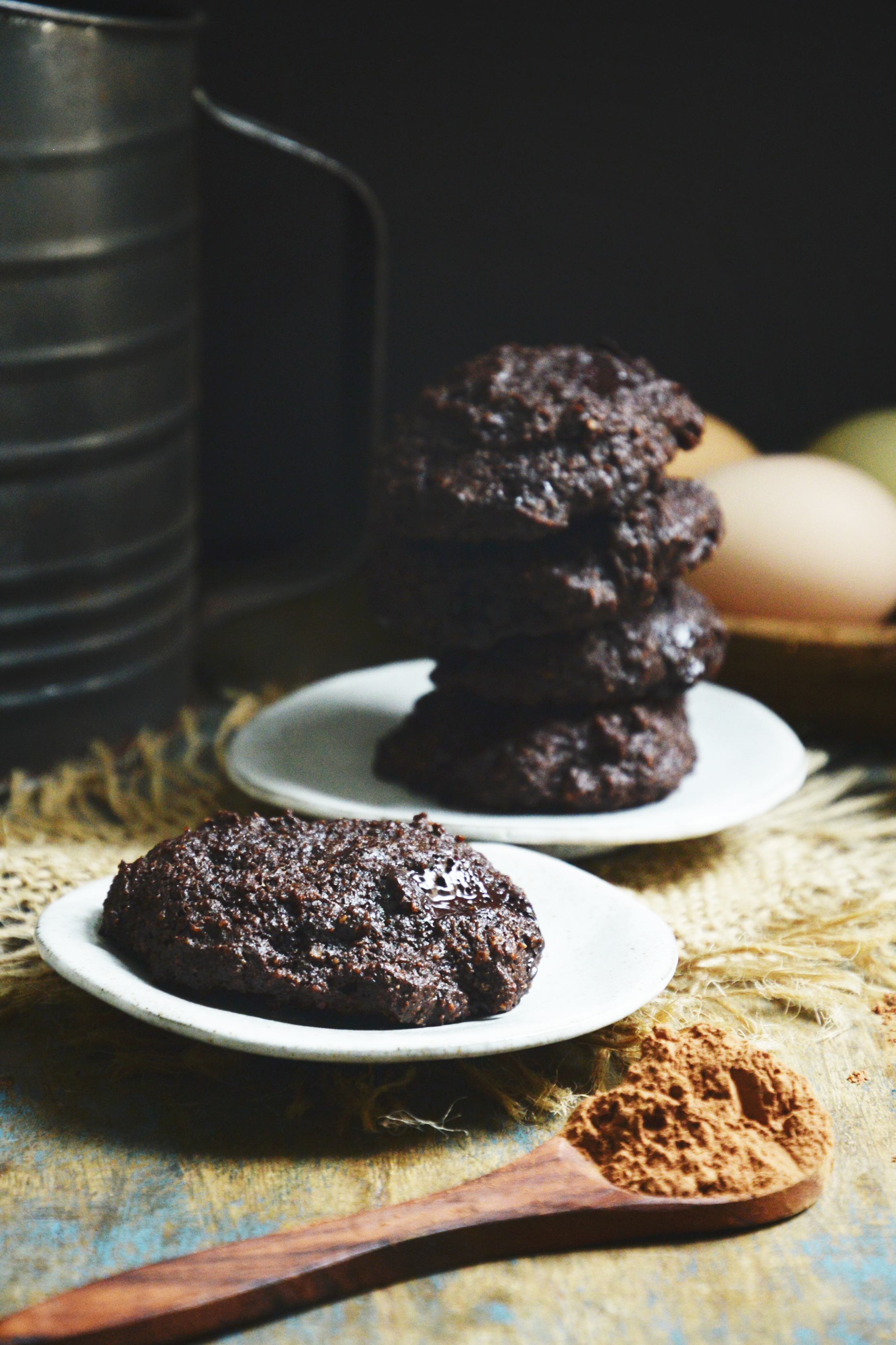 Keto-Friendly Double Chocolate Chip Cookies-with eggs and sifter in background.