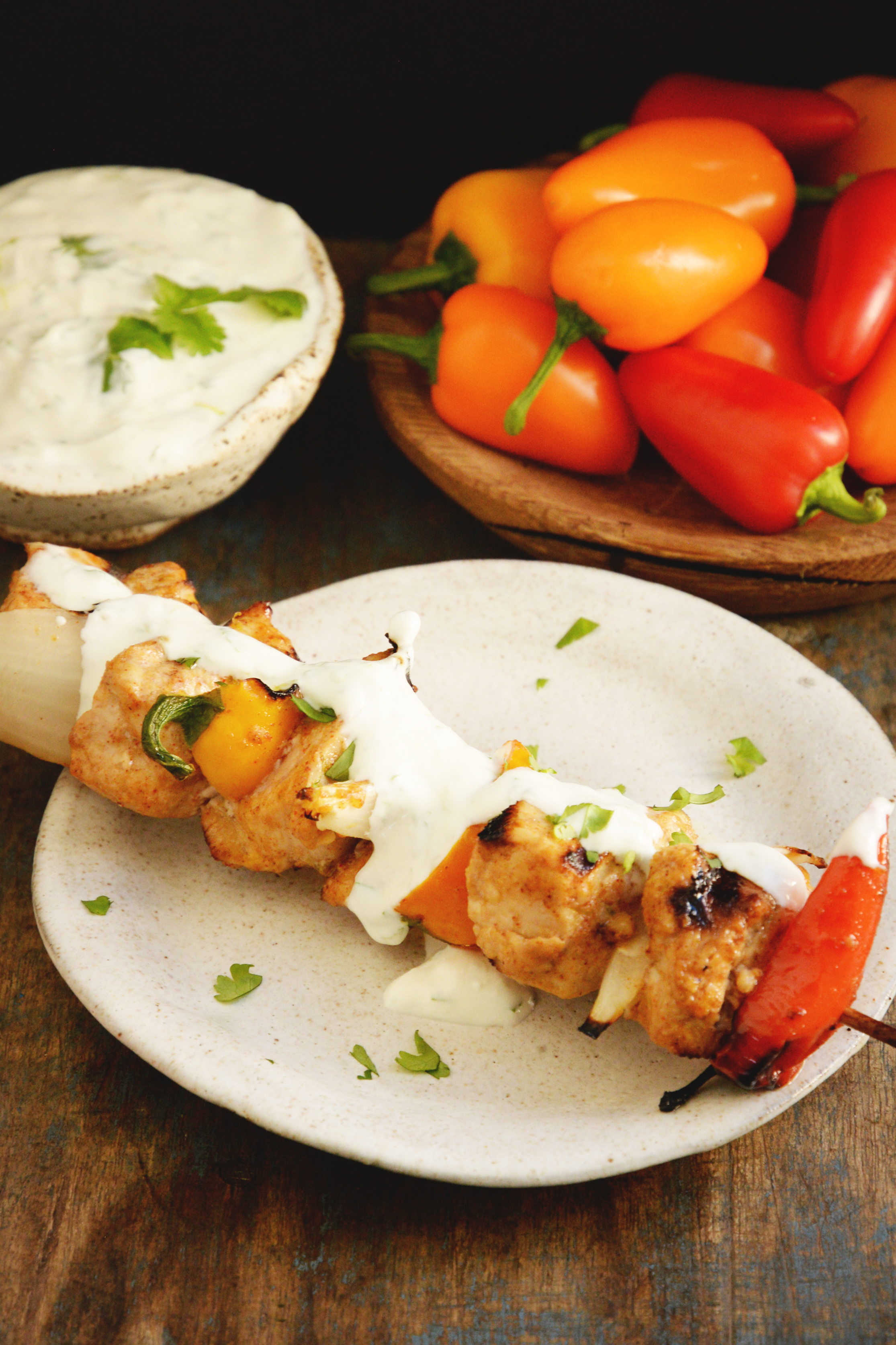 Grilled Fajita Chicken Kabobs-overhead shot with cilantro lime sauce.