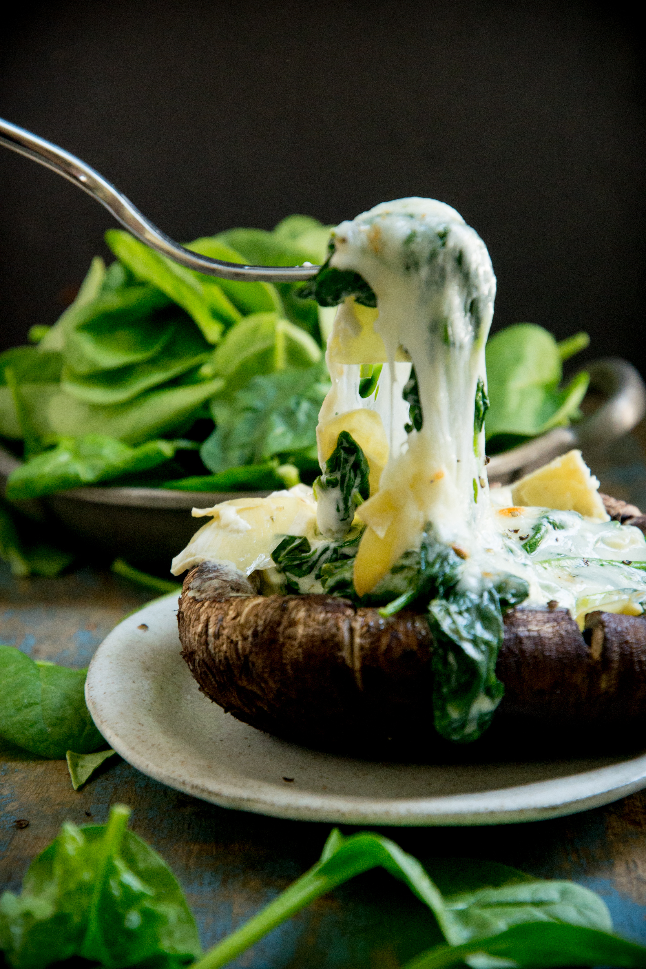 Spinach and Artichoke Stuffed Mushrooms-taking a forkful.