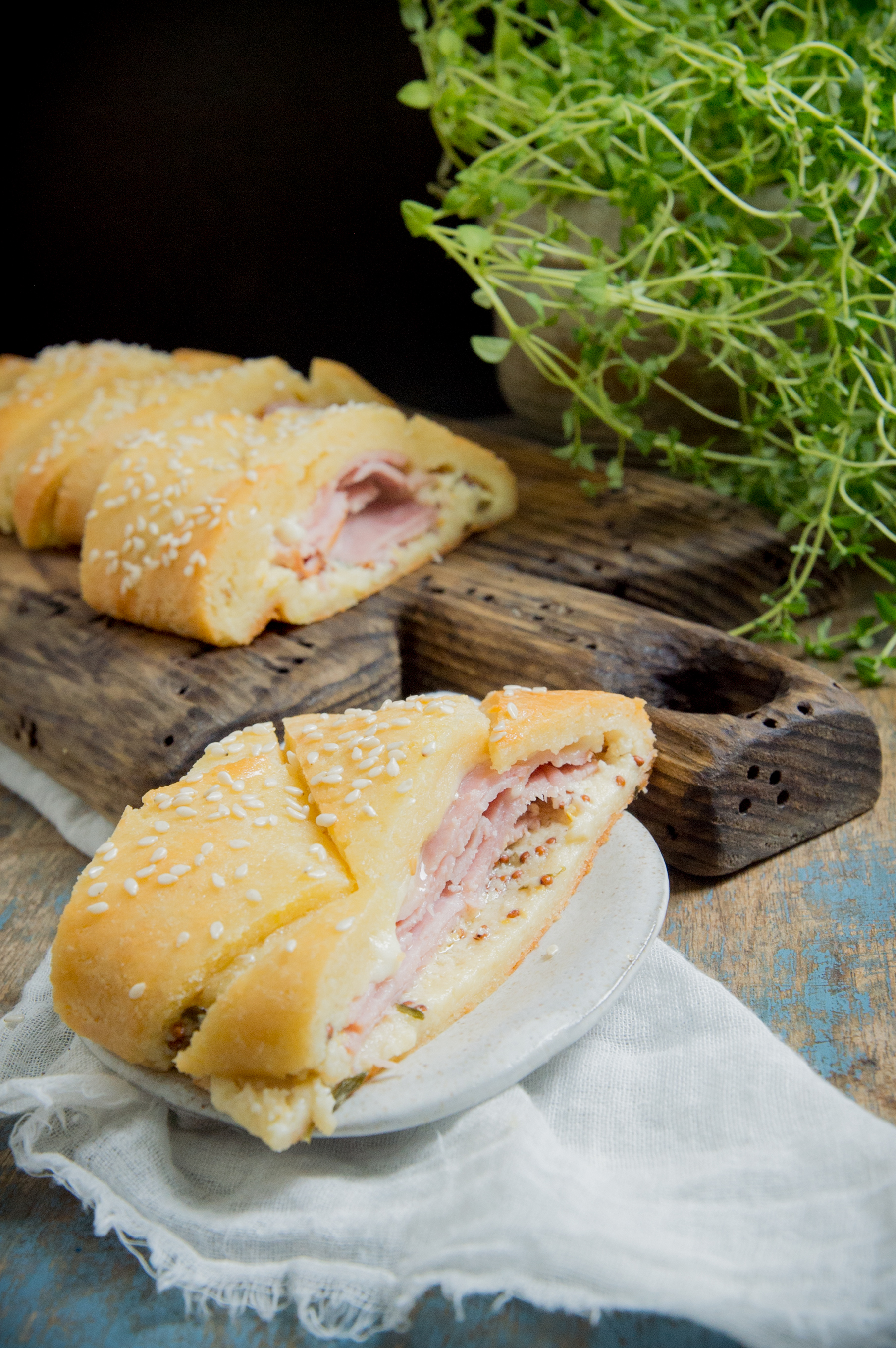 Low-Carb Ham and Cheese Sandwich Braid-a slice on a plate.