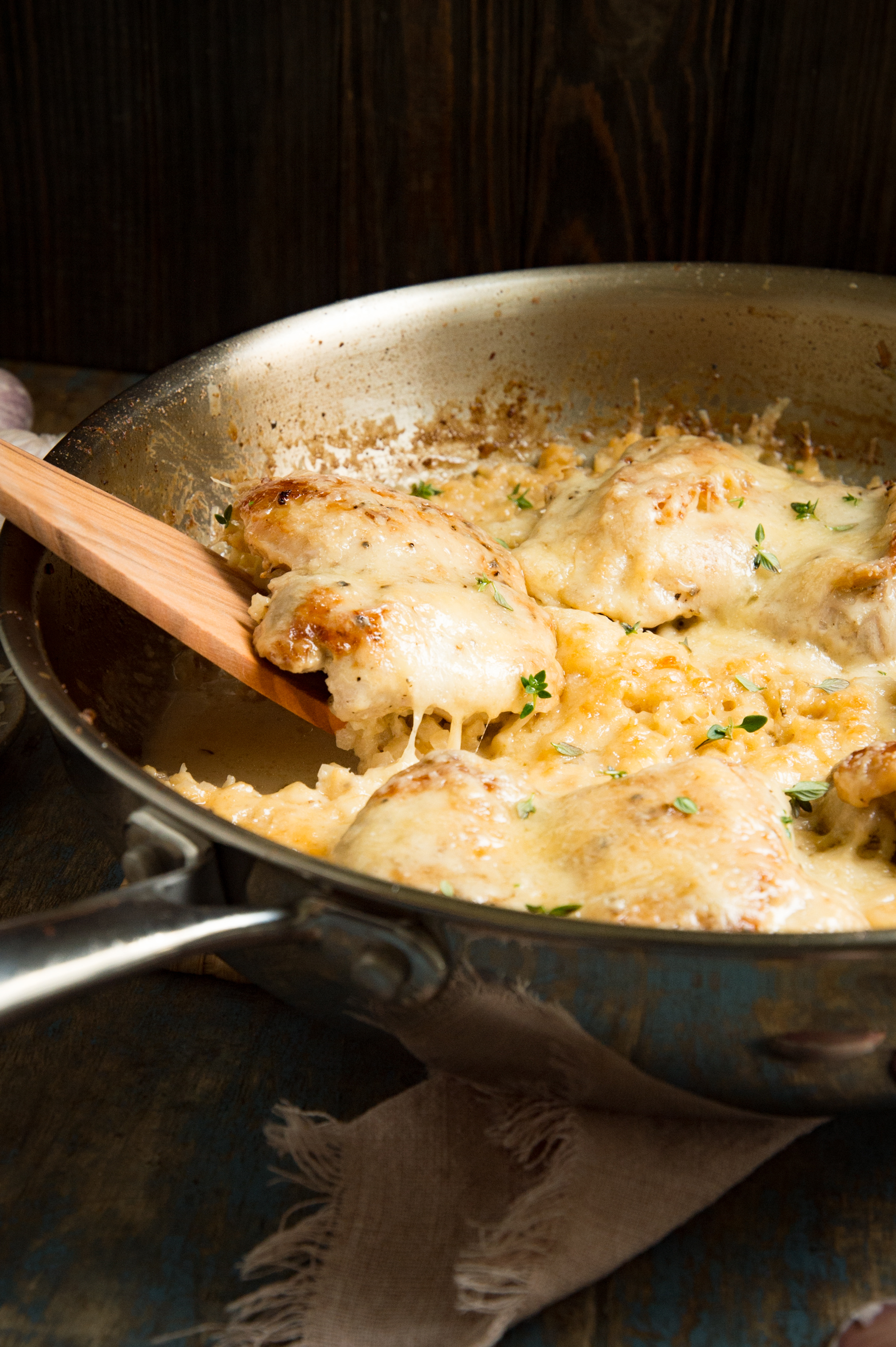 Low-Carb One Skillet Creamy Garlic Parmesan Chicken-removing from the pan.
