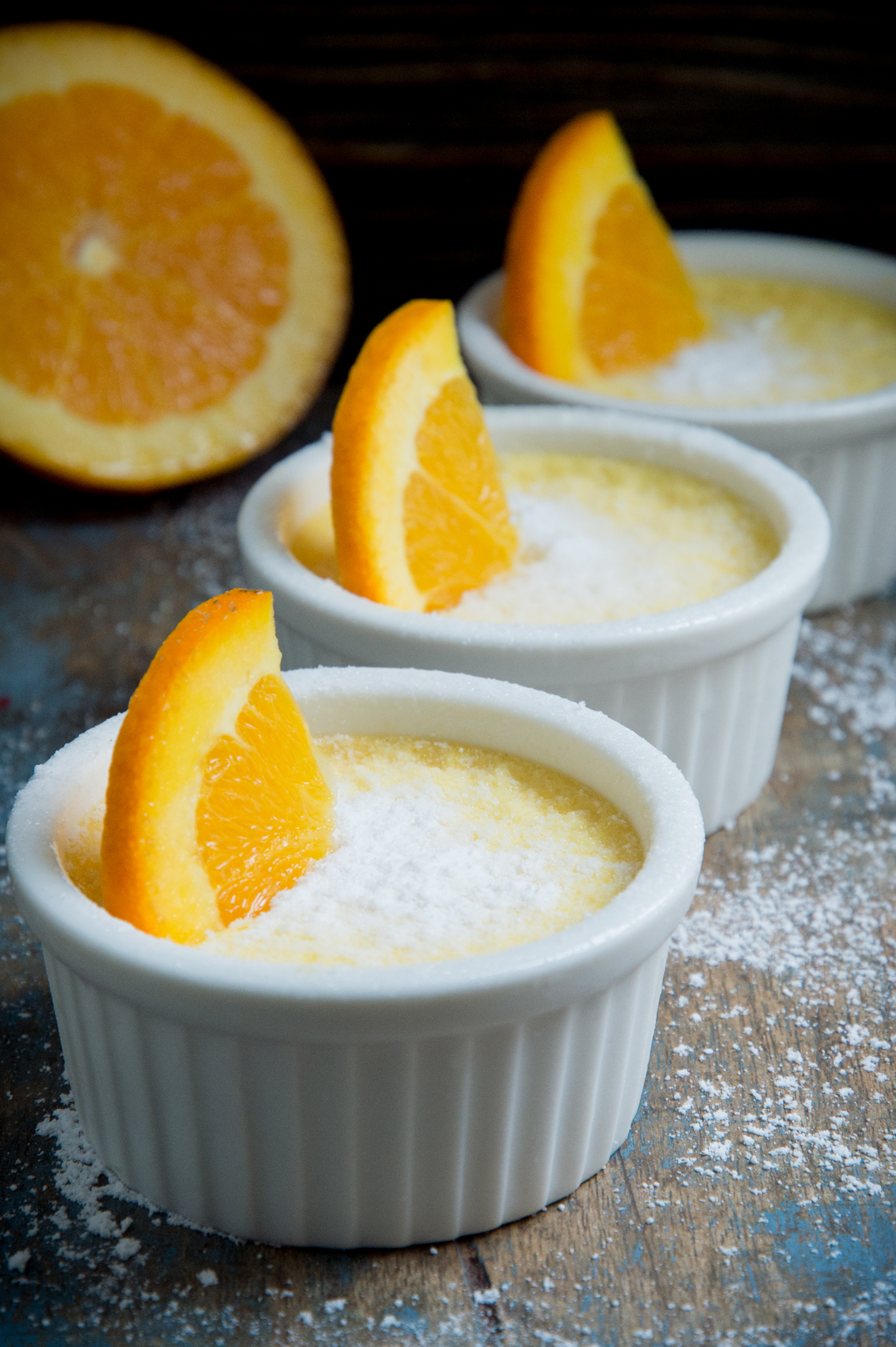 Low-Carb Orange Pots de Crème-garnished with sweetener and orange slice.