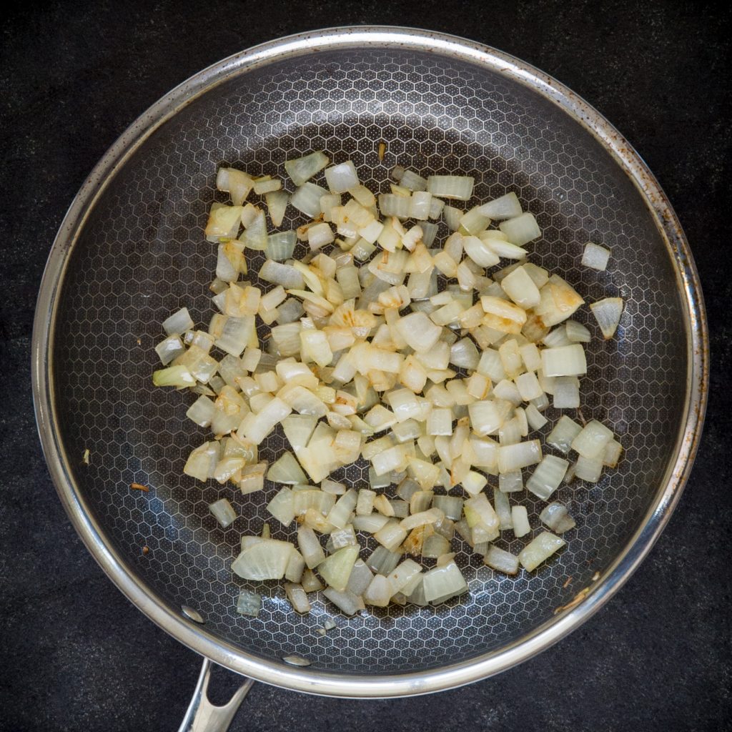 Sauteing onions in a pan.