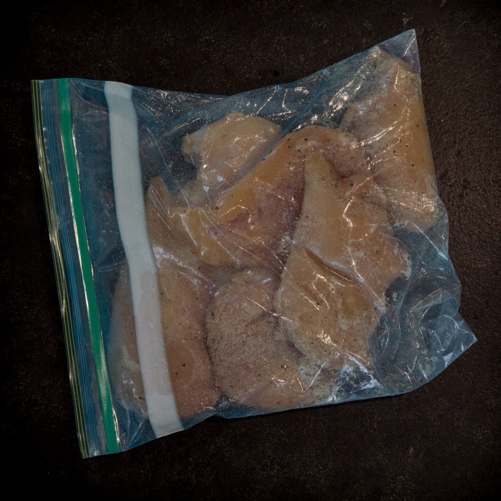 Coating the chicken in a Ziplock pouch.