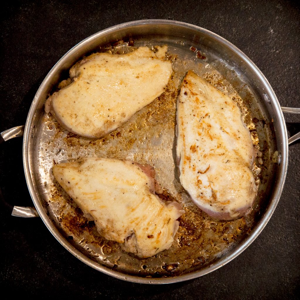Cooking chicken in a pan.