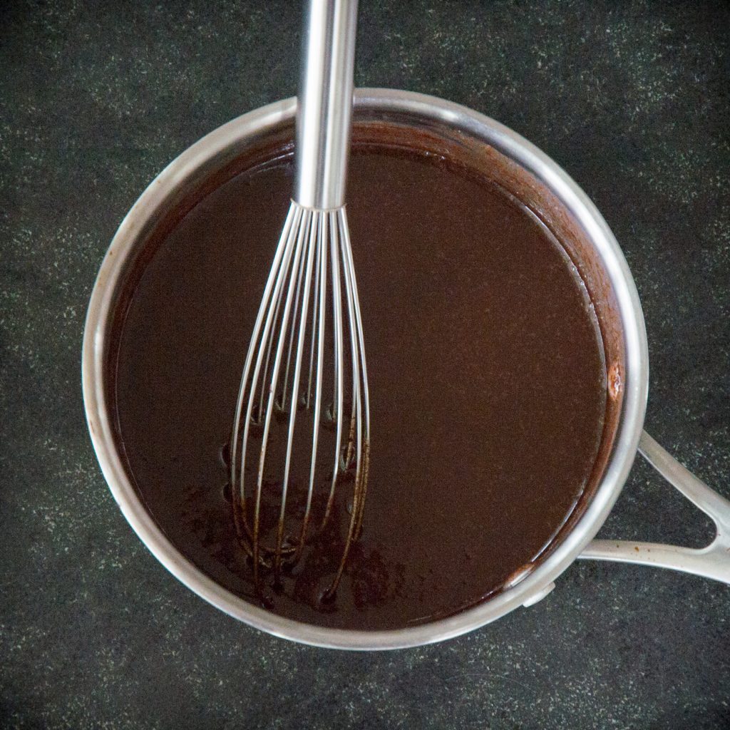 Whisking in the vanilla extract into the pan.