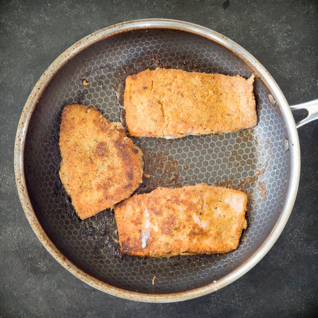 Cooking the salmon on a pan.