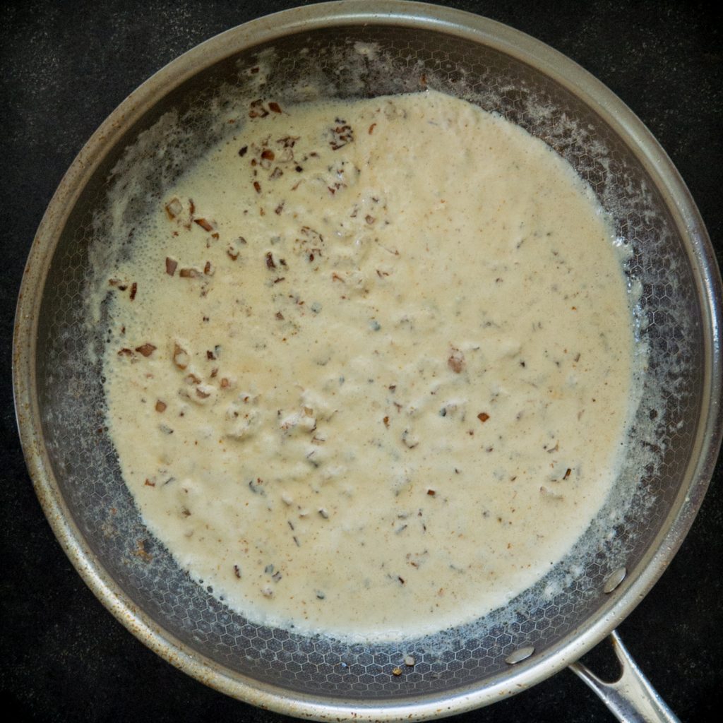 Sauteing ingredients for mustard tarragon cream sauce.