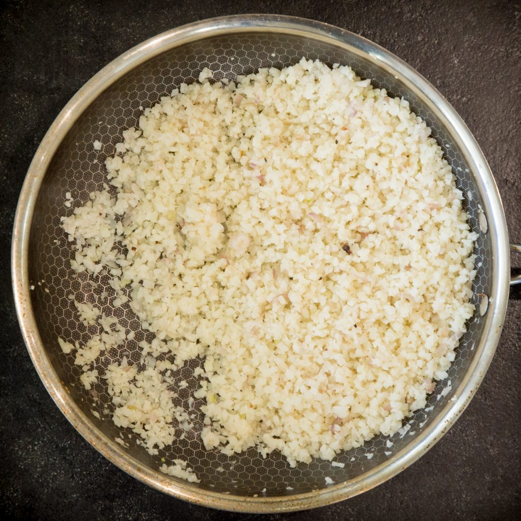 Cooking cauliflower risotto in a pan.