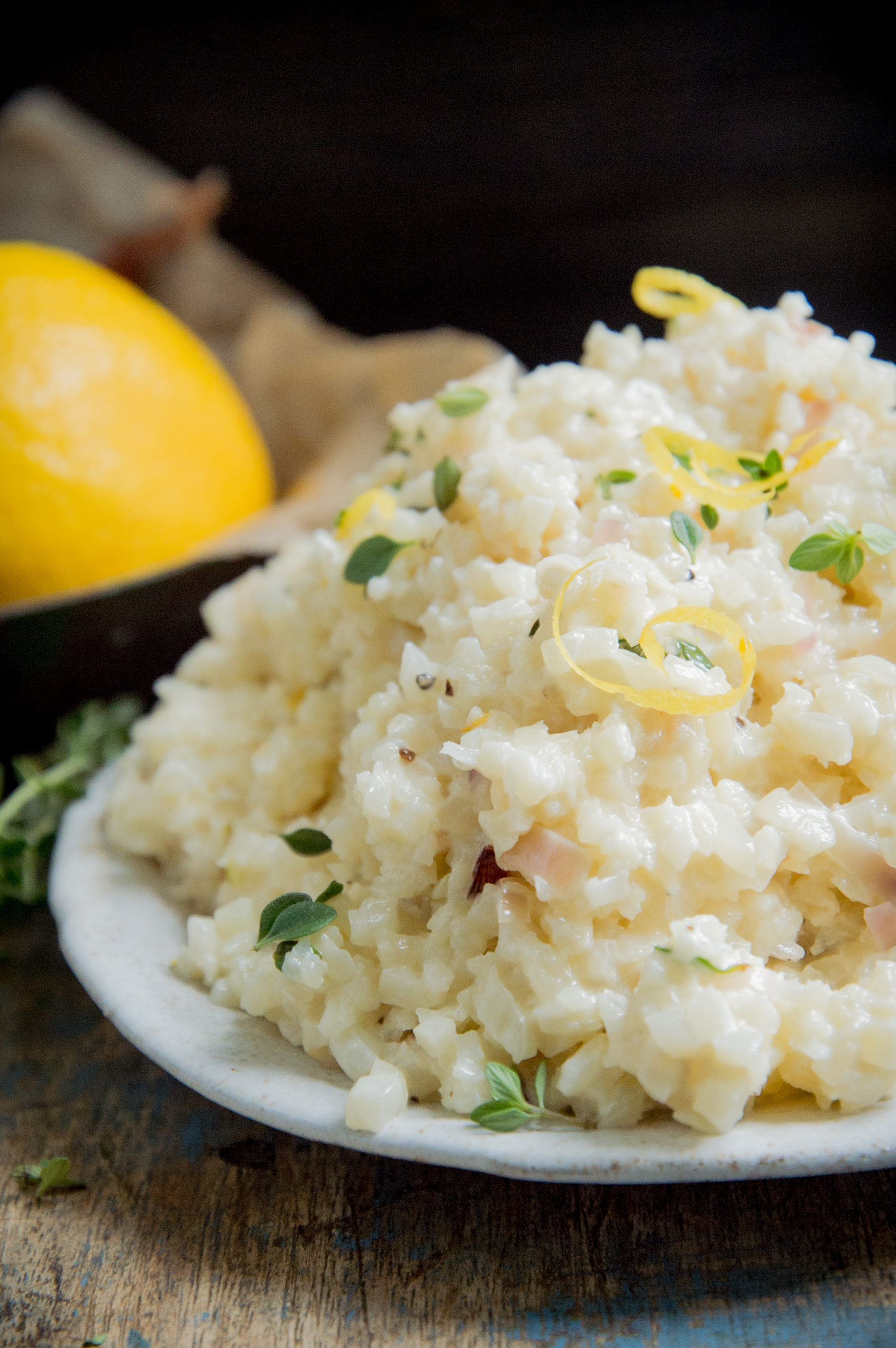 Cauliflower rice garnished with thyme and lemon zest.