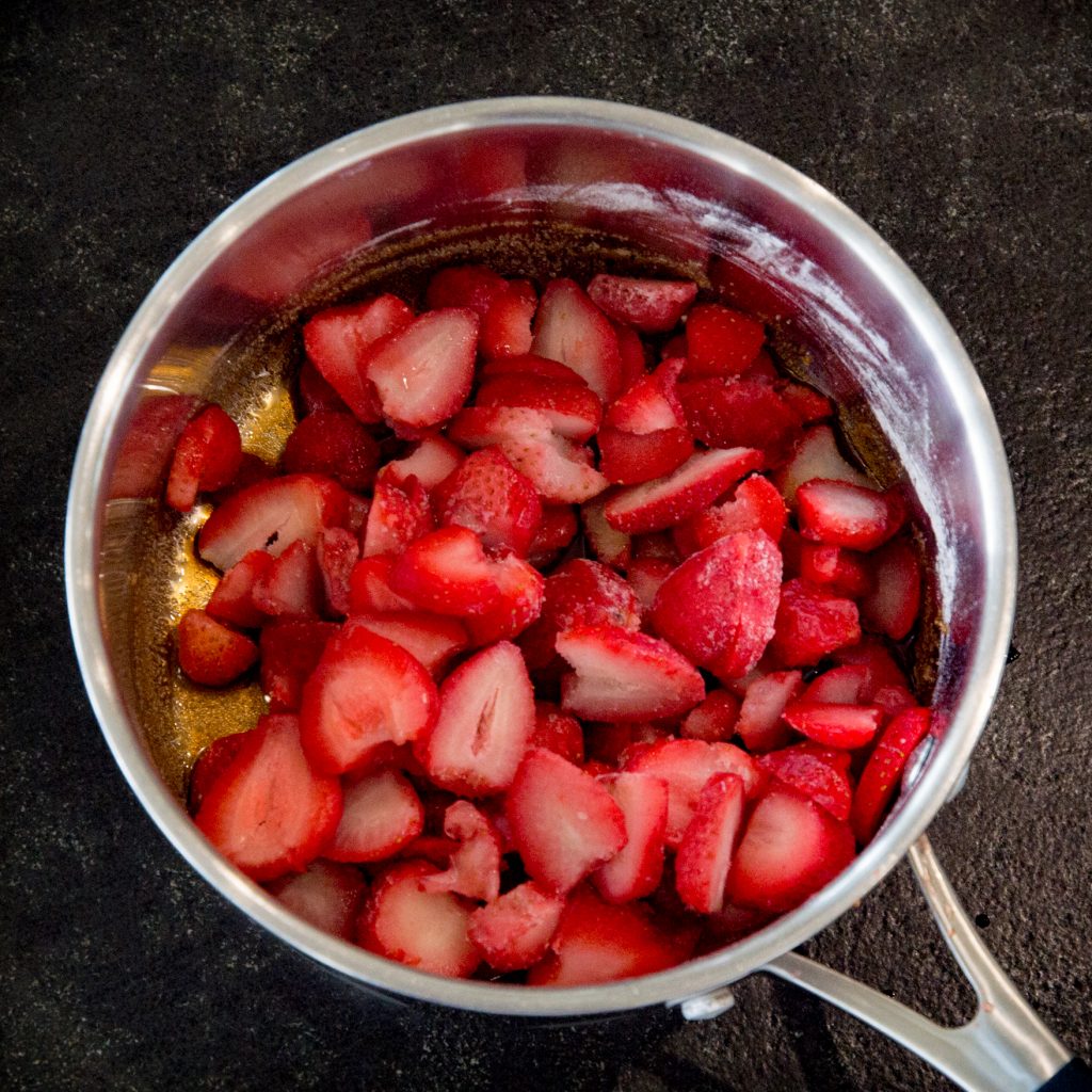 Overhead shot of strawberries in a saucepan.