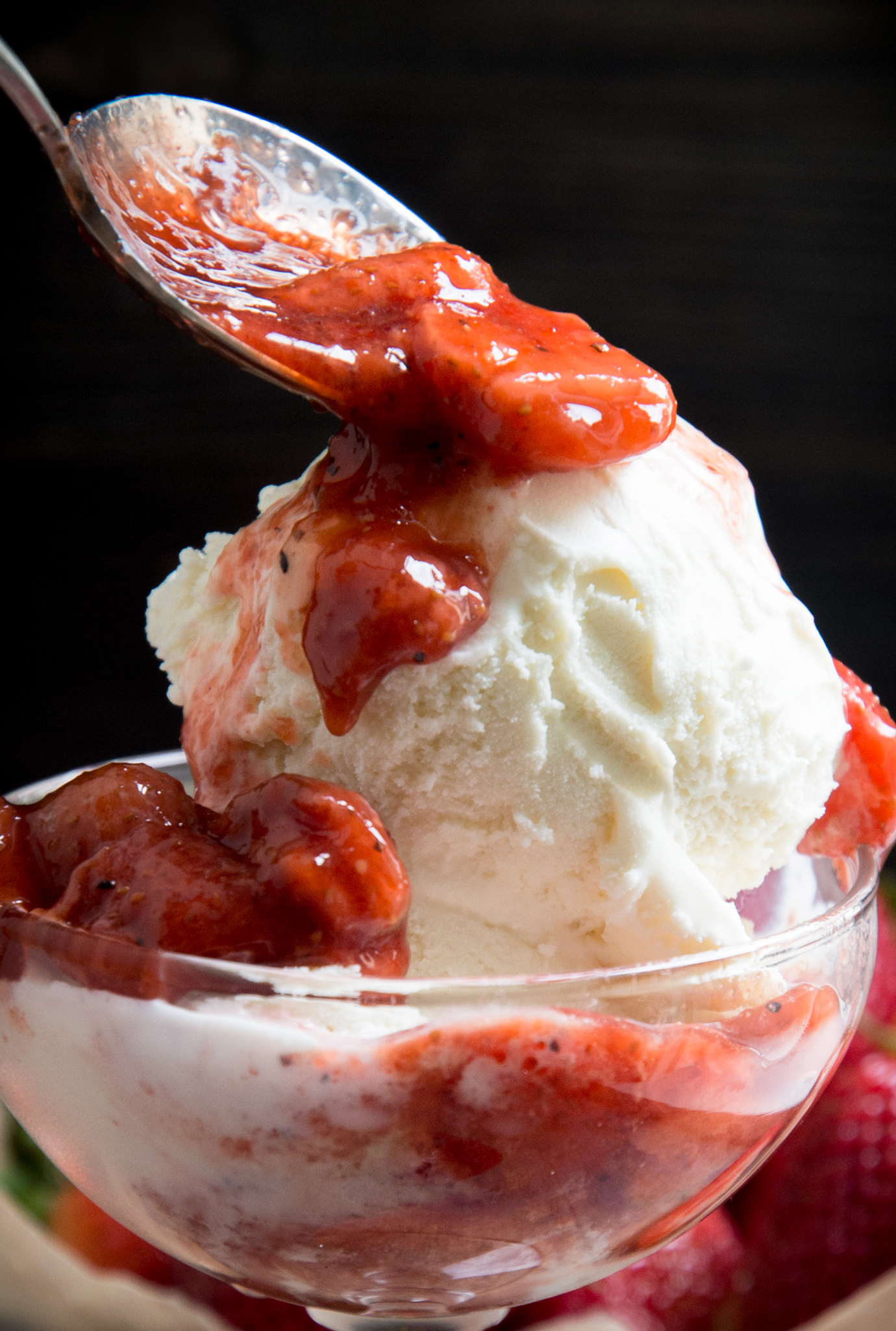 Photo of ice cream with strawberry sauce on top