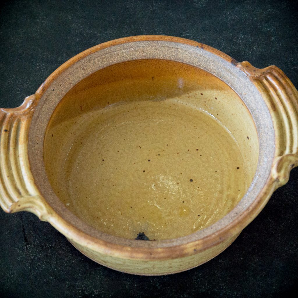 Process photo of oiled casserole dish.