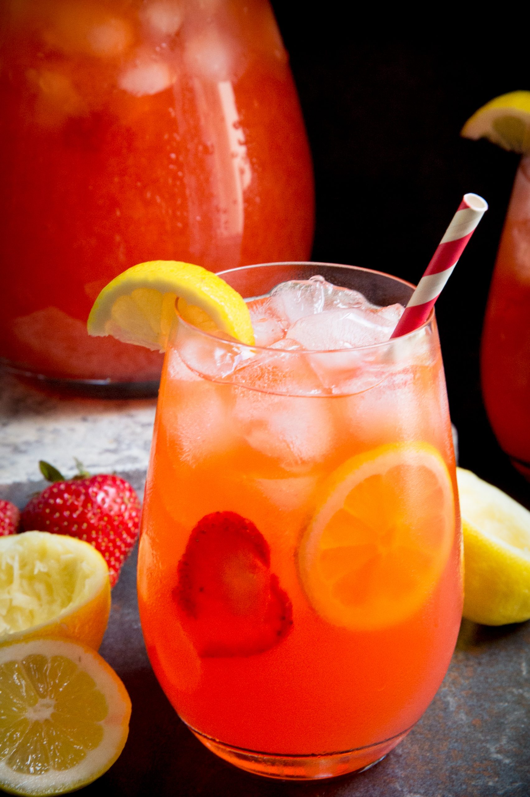 Glass of sugar-free strawberry lemonade in front of pitcher