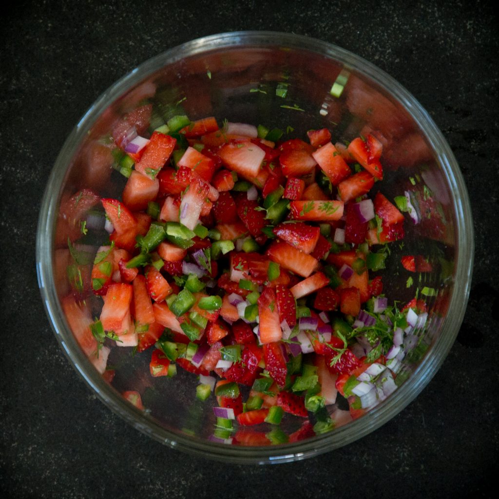 Making strawberry salsa for the fillets.