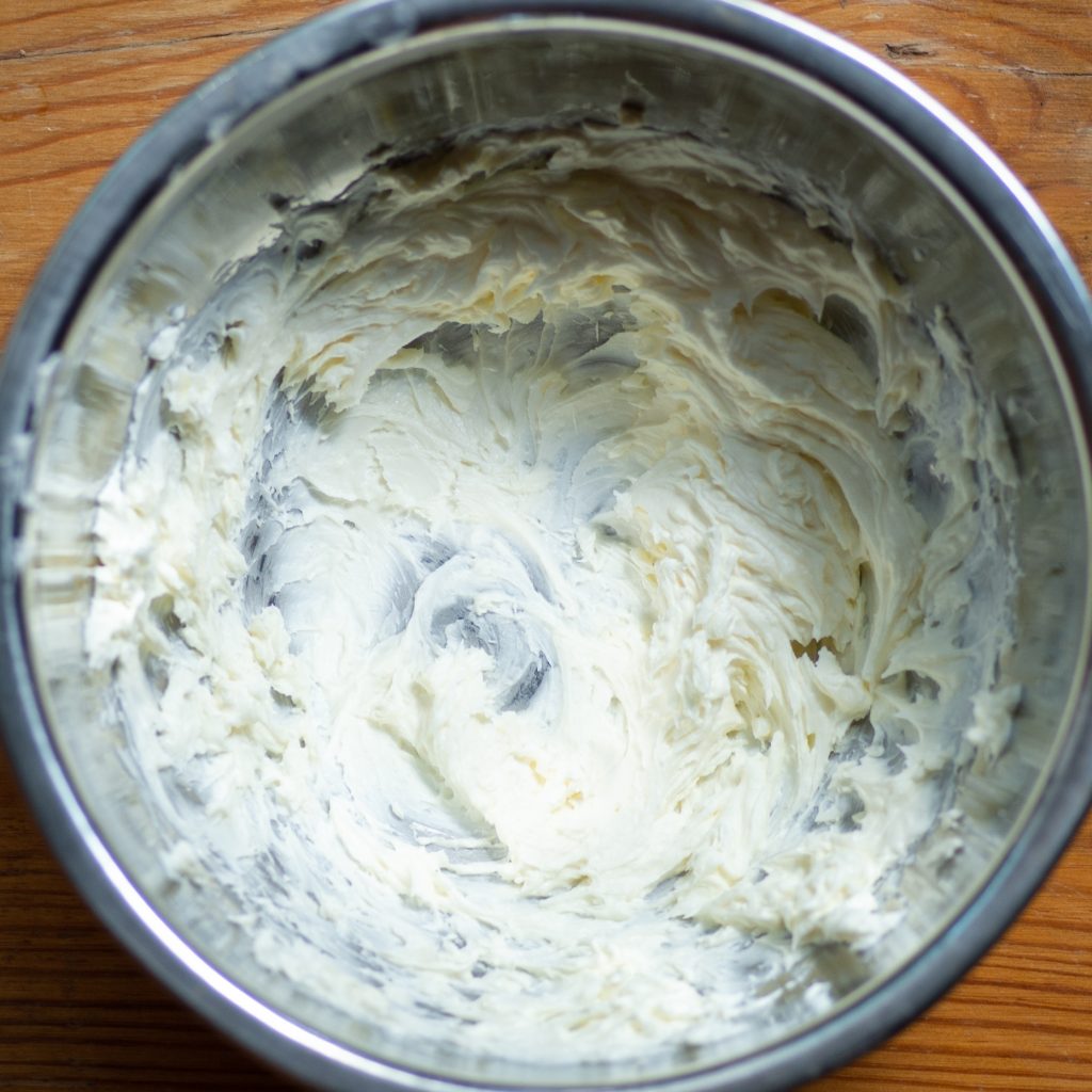Process photo of cream cheese and butter mixed together to form smooth dough.