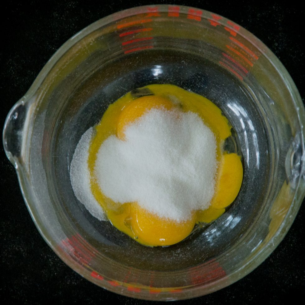 mixing egg yolks and sweetener.