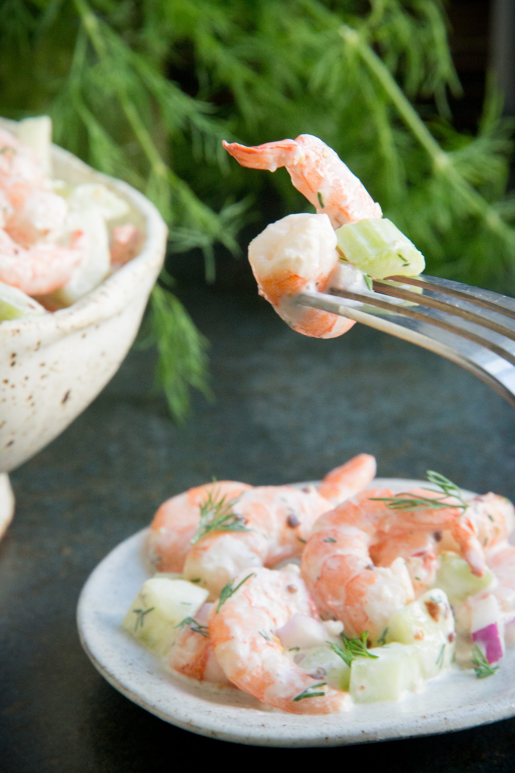 Taking a bite of our creamy shrimp salad.