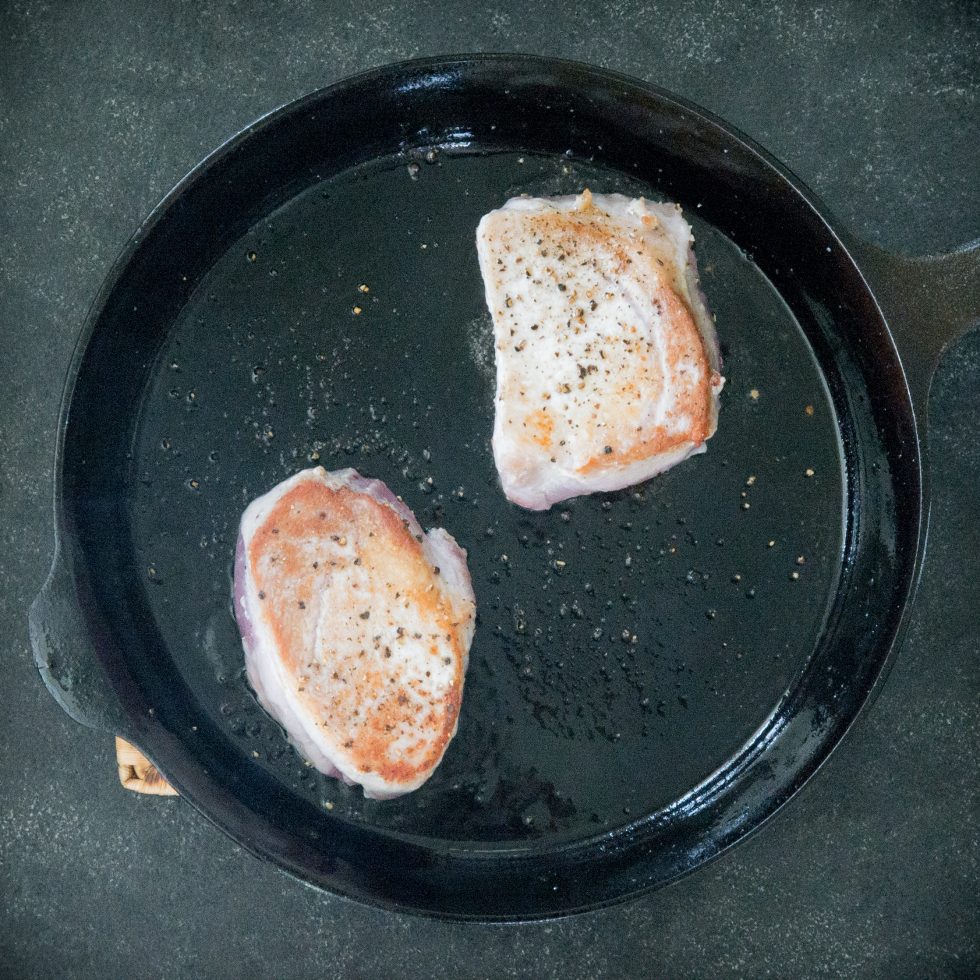 Browning the pork chops.