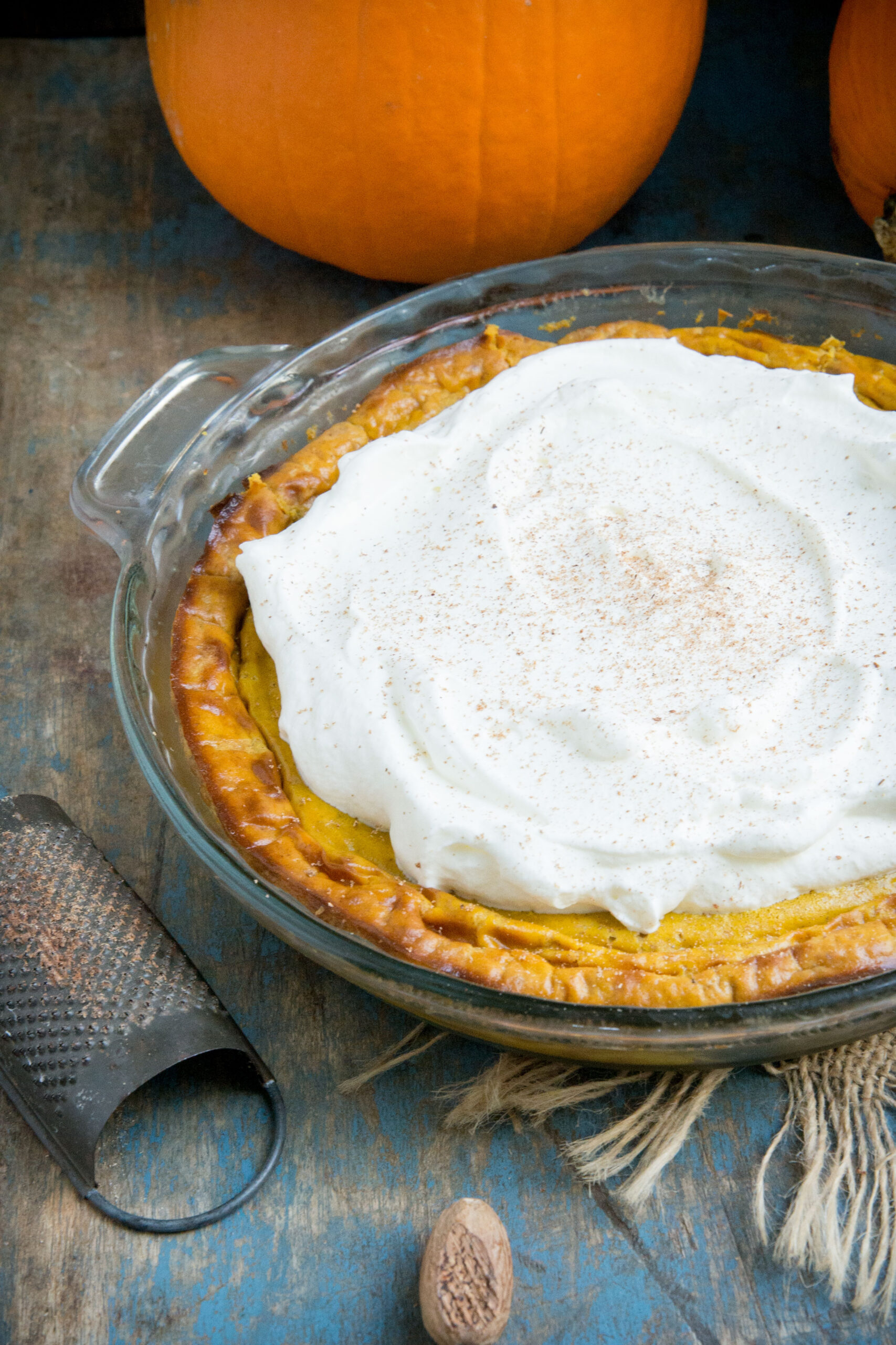 Crustless pumpkin pie topped with whipped cream.