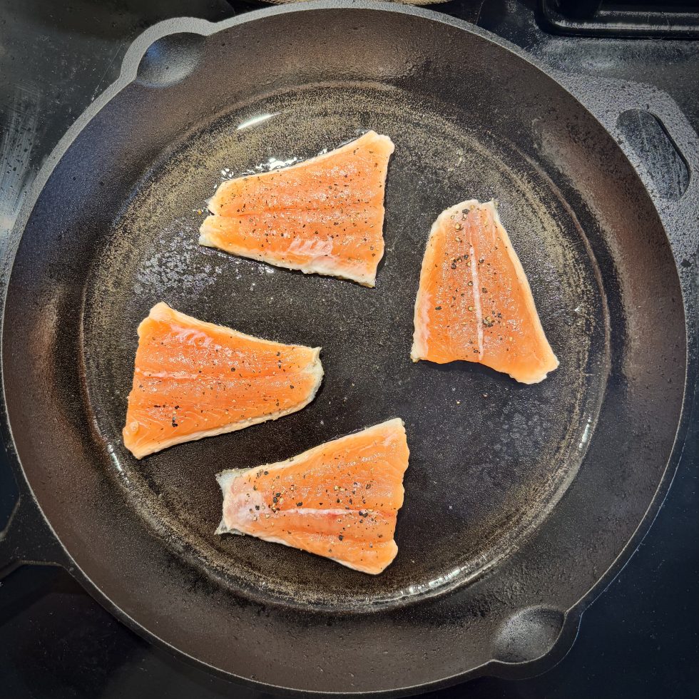 Salmon in pan, skin side down