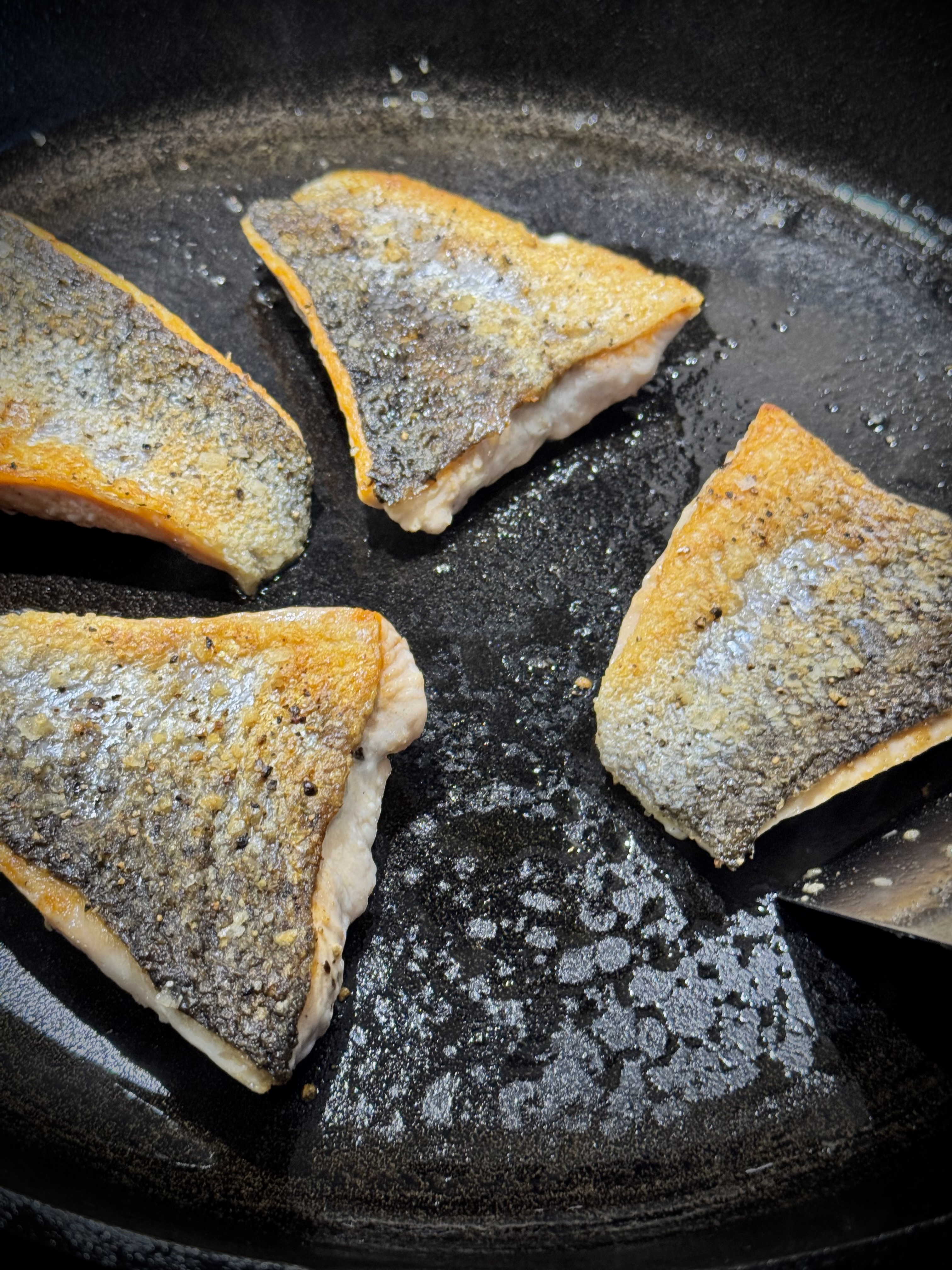 Salmon in pan, skin side up