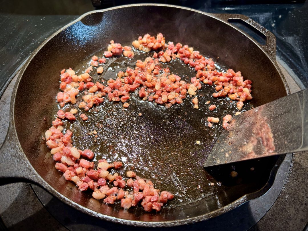 Pancetta frying in pan