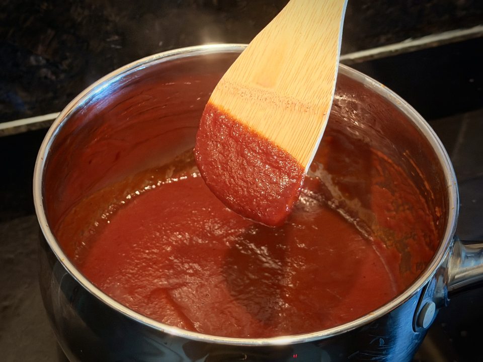 BBQ Sauce coating the back of a wooden spoon
