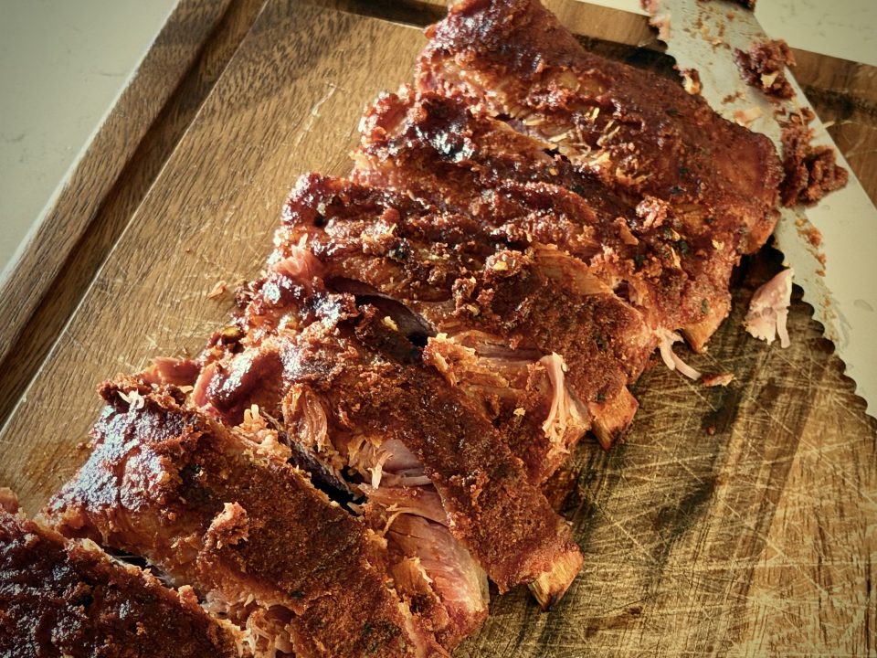 Cutting ribs on a wooden cutting board